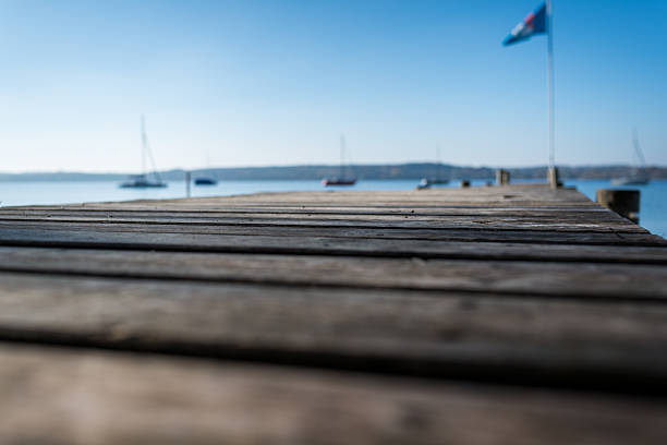 Wood table top on blur sea background. Summer, nature concepts.