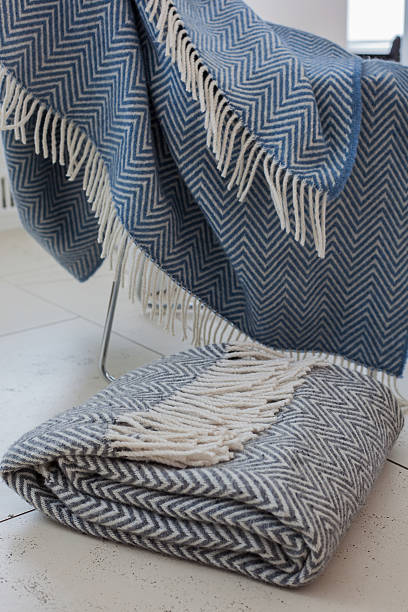 istock Plaid hanging on a chair and lay  the floor 618936068