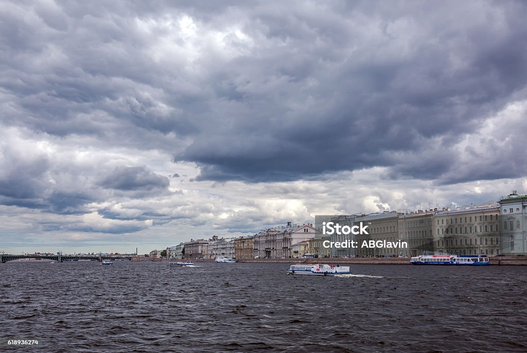 Dark water and thunderstorm clouds in Saint Petersburg Usual dark water of Neva river under thunderstorm clouds in Saint Petersburg in a summer day along the famous riverside Architecture Stock Photo