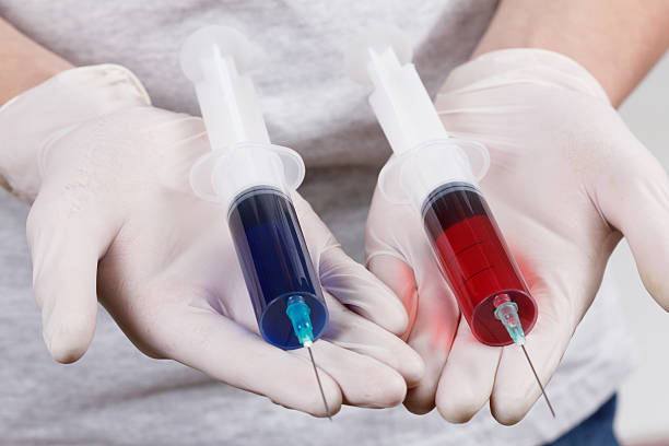istock Hand with syringes, ready for narcotic injection 618937380