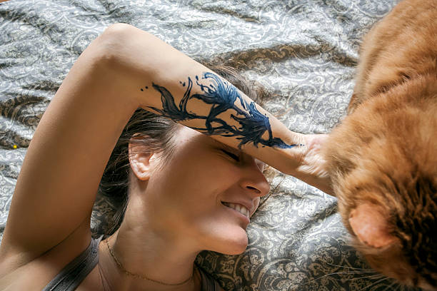 Woman in her bed with her beloved cat