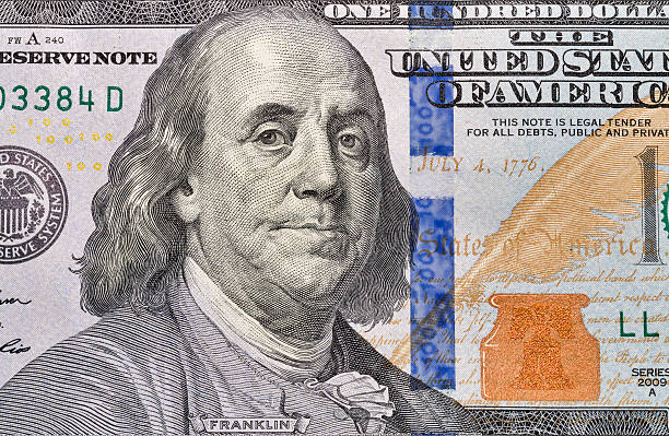 istock One hundred dollar bill fragment closeup 618940520