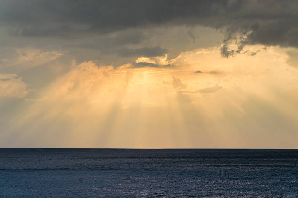 istock Dramatic sunset over cloudy sky and dark blue sea 618942616