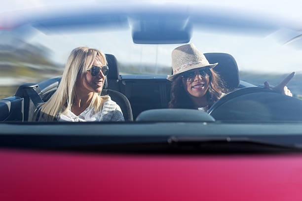 istock Two beautiful young women sitting in the car 618944310