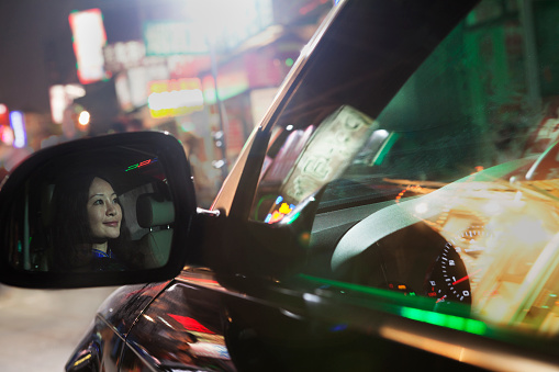 Businesswoman driving car at night