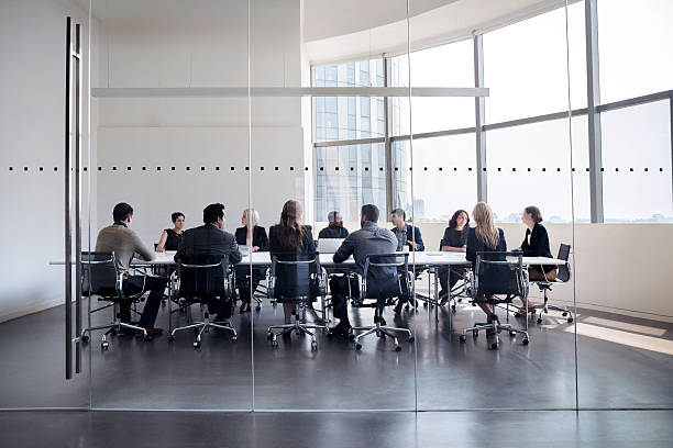 Colleagues at business meeting in conference room Colleagues at business meeting in conference room conference table stock pictures, royalty-free photos & images