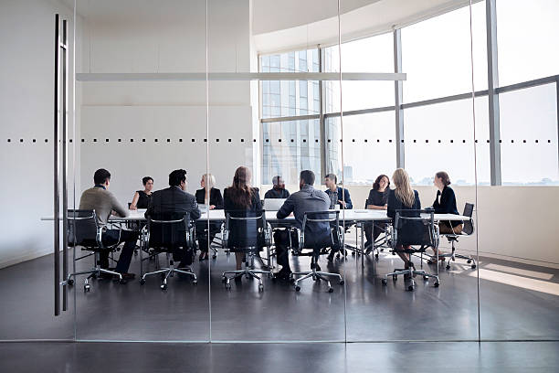 colleagues at business meeting in conference room - unity ideas gear concepts imagens e fotografias de stock