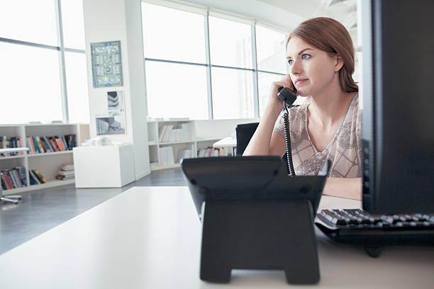 Woman talking on phone in business office