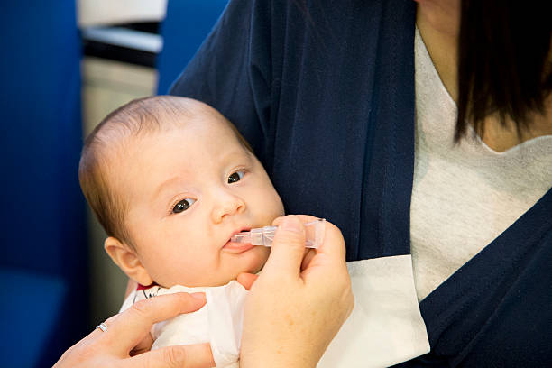 Baby Receiving Oral Vaccination stock photo