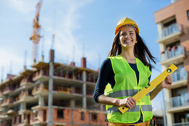 istock Young female engineer holding a level 618949316