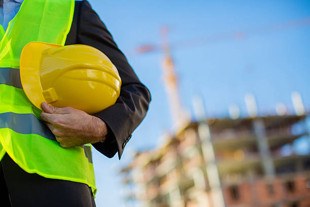 istock Young male engineer holding a yellow helmet 618949702