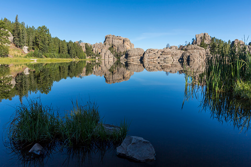 A calm reflective lake in the Black Hills.