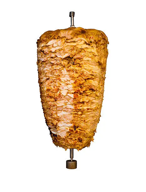 Grilled skewered chicken on spit, a traditional meat shaved, served inside kebab sandwich in Mediterranean and Arab countries in Middle East, cooked isolated on pure white background