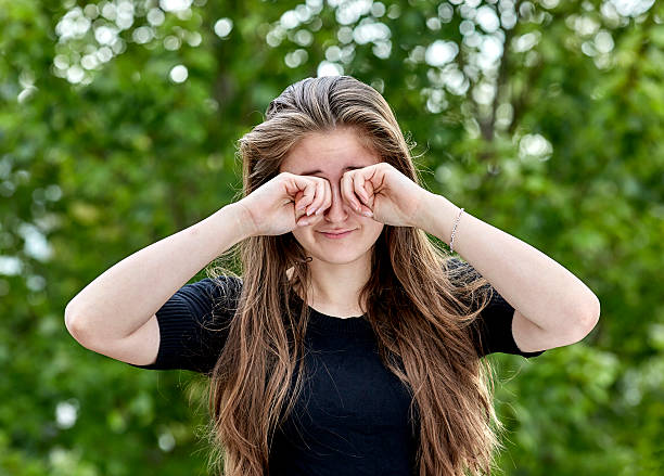 istock Sleepy Woman rubbing her Eyes 618951812