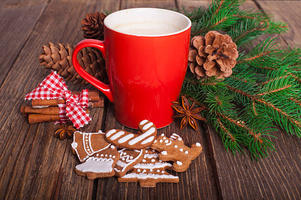 istock Christmas cappuccino and gingerbread cookies infront Christmas tree 618952526