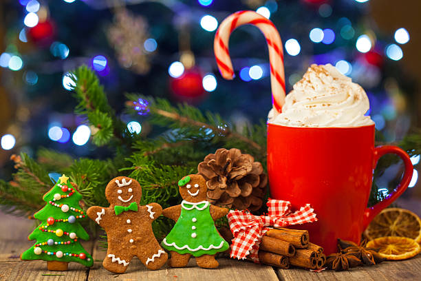 istock Christmas cappuccino and gingerbread cookies infront Christmas tree 618952956