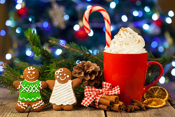 istock Christmas cappuccino and gingerbread cookies infront Christmas tree 618953010