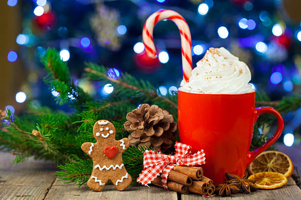 Christmas cappuccino and gingerbread cookies infront Christmas tree