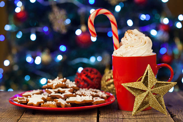 istock Christmas cappuccino and gingerbread cookies infront Christmas tree 618953082