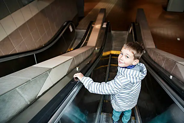 Photo of boy on the escalator in the metro