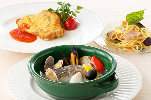 A steaming bowl of flavorful seafood soup, featuring mussels, shrimp, and clams in a delicious broth