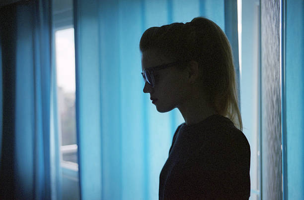 istock Woman spy standing near a window 618953662