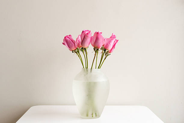 istock Pink roses in glass vase 618954108