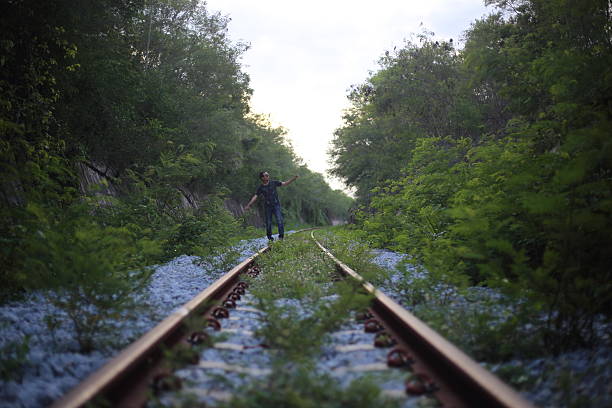 istock The man goes on rails, maintaining a balance poised 618955698