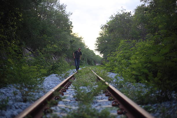 istock The man goes on rails, maintaining a balance poised 618955802