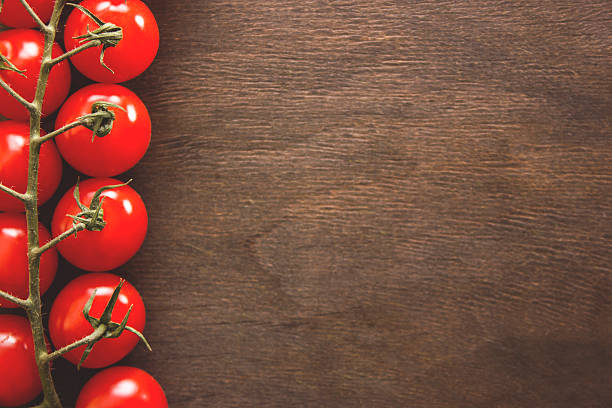 istock Bunch of tomatoes on a wooden background 618956888