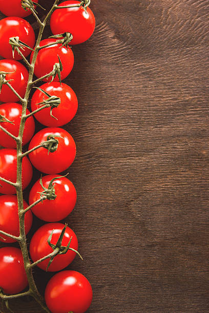 istock Bunch of tomatoes on a wooden background 618956932