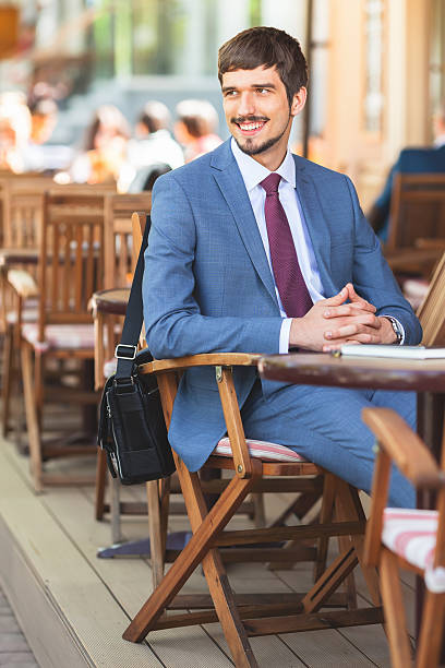 istock Handsome male has a french breakfast at sidewalk cafe 618958500