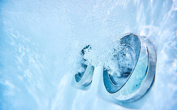 massage jets in whirlpool underwater view of outdoor whirlpool with active massage jets hot tub stock pictures, royalty-free photos & images