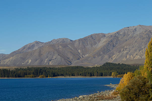 istock Stone Beach Mountain Landscape, Lake Tekapo in autumn 618963728