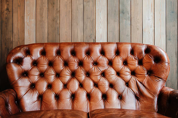 istock Old leather sofa on wooden background, void 618964914