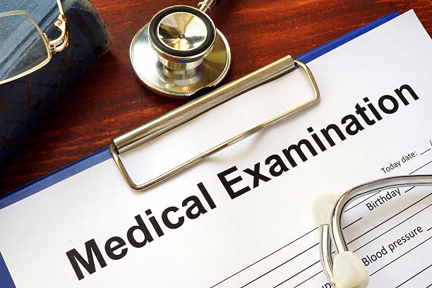 istock Medical Examination form on a wooden table. 618966106