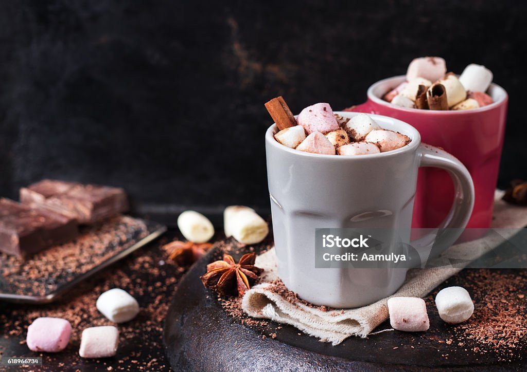 Hot chocolate with marshmallows and spices on grunge dark table Hot chocolate with marshmallows and spices on grunge dark table. Selective focus, tasty holidays concept. Drink for fall and winter Anise Stock Photo