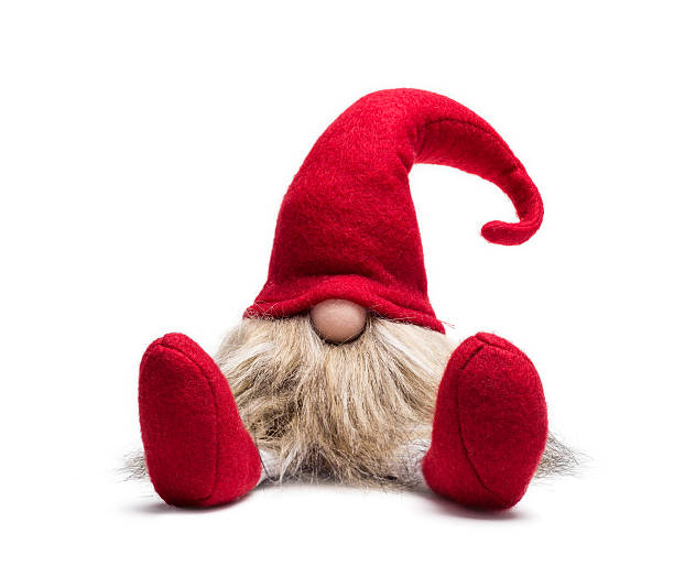 Seated red christmas dwarf Red sitting christmas elf with pointed cap isolated as template elf stock pictures, royalty-free photos & images