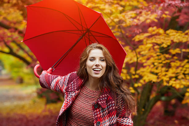 istock woman in autumn park 618969220