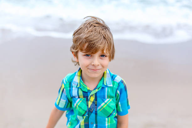 istock little kid boy on the beach of ocean 618969410