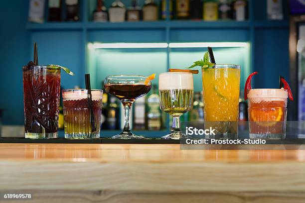 Creative Alcohol Cocktails In Night Club Bar Stock Photo - Download Image Now - Drink, In A Row, Alcohol Abuse