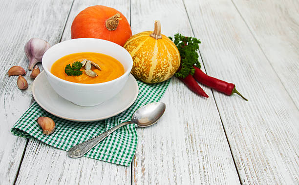 istock Pumpkin soup with fresh pumpkins 618971812