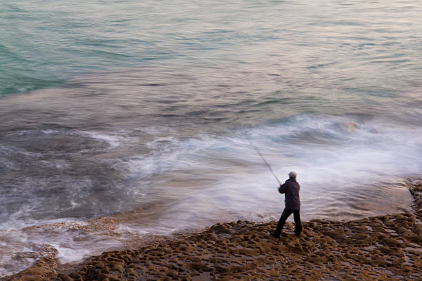 istock Man fishing at dusk. 618972826