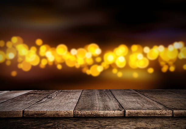 istock Blurred abstract golden spot lights with wood 618972994