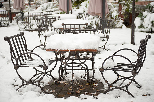 istock metal table and chairs covered with snow 618973118