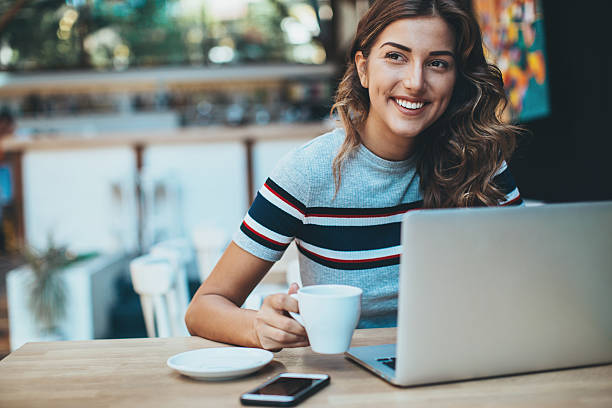 istock Beautiful girl with laptop in cafe 618973250