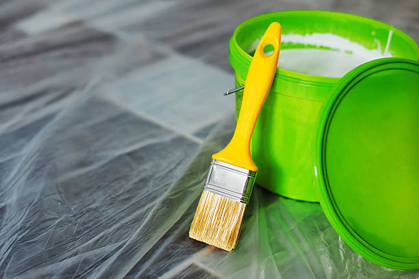 istock Yellow paint brush and green bucket 618973272