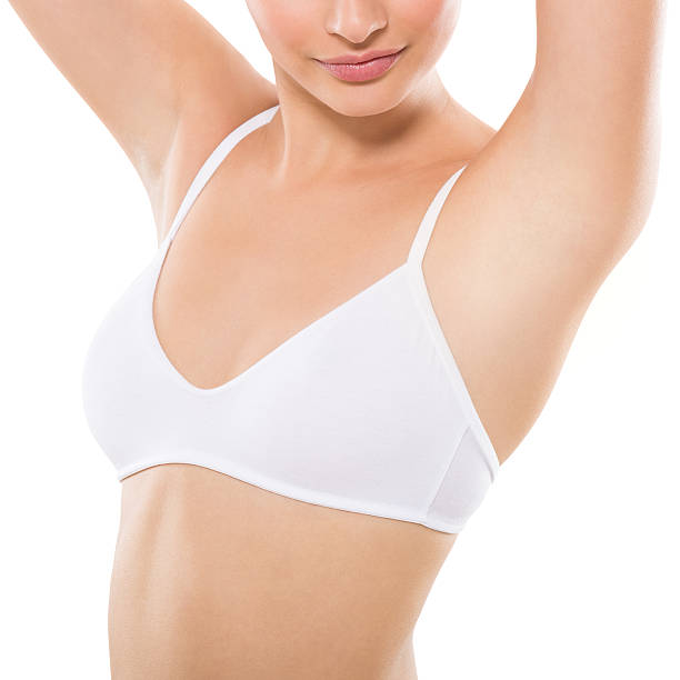 Armpit epilation Closeup of a beautiful young woman showing her smooth armpit isolated on white background. Girl holding her arms up and showing clean underarms. Hairs removal and depilation concept. underarm stock pictures, royalty-free photos & images