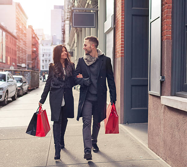 Couple walking with shopping bags stock photo