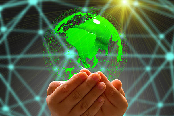 istock kid's hand holding globe in dark background 618975940